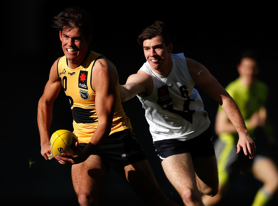AFL 2017 U18 Championships - Vic C v WA MELBOURNE, AUSTRALIA - JUNE 30: Brandon Starcevich of Western Australia is tackled by Aidan Quigley of Vic Country during the 2017 AFL Under 18 Championships match between Vic Country and Western Australia at Etihad Stadium on June 30, 2017 in Melbourne, Australia. (Photo by Adam Trafford/AFL Media)